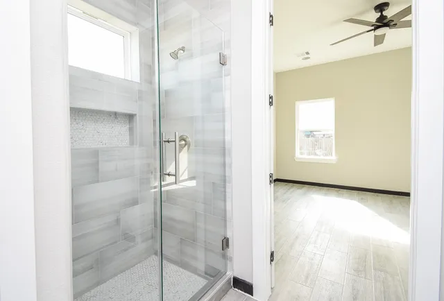 a bathroom with a bathtub and shower