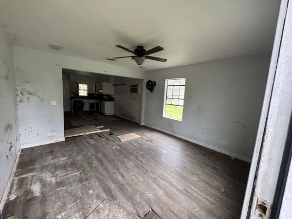 wooden floor in an empty room with a window