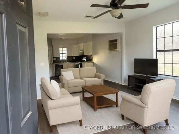 a living room with furniture and a flat screen tv