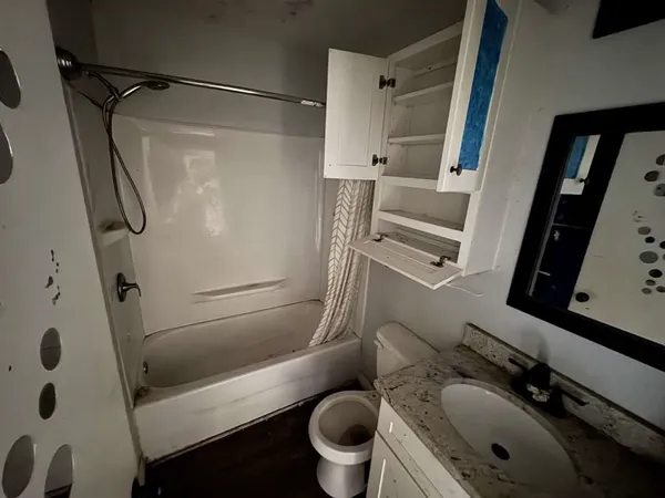 a bathroom with a sink toilet and shower