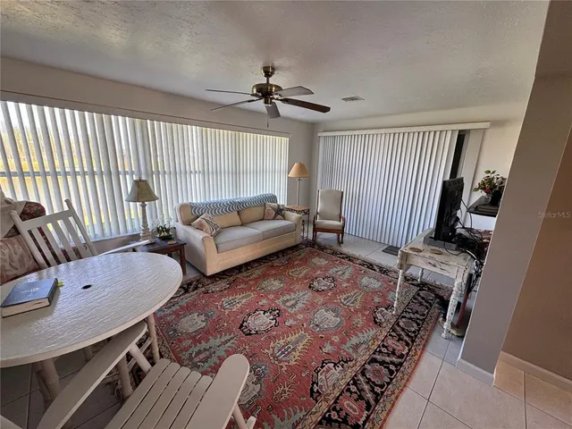 a view of a living room with a floor to ceiling windows and floor to ceiling window