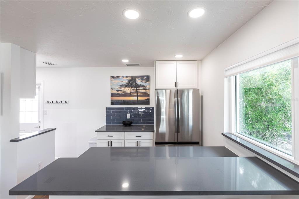 6020 Midnight Pass Road, Unit 48 Sarasota, FL 34242 - Photo 12 of 17 a view of a kitchen with furniture and stainless steel appliances