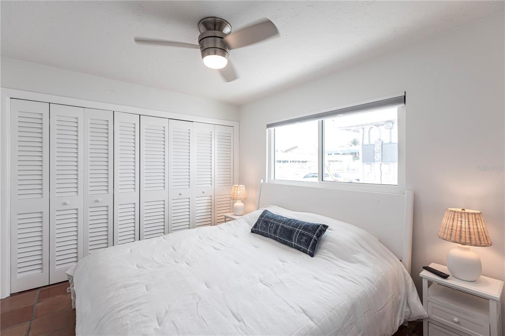 6020 Midnight Pass Road, Unit 48 Sarasota, FL 34242 - Photo 14 of 17 a bedroom with a large bed and a window