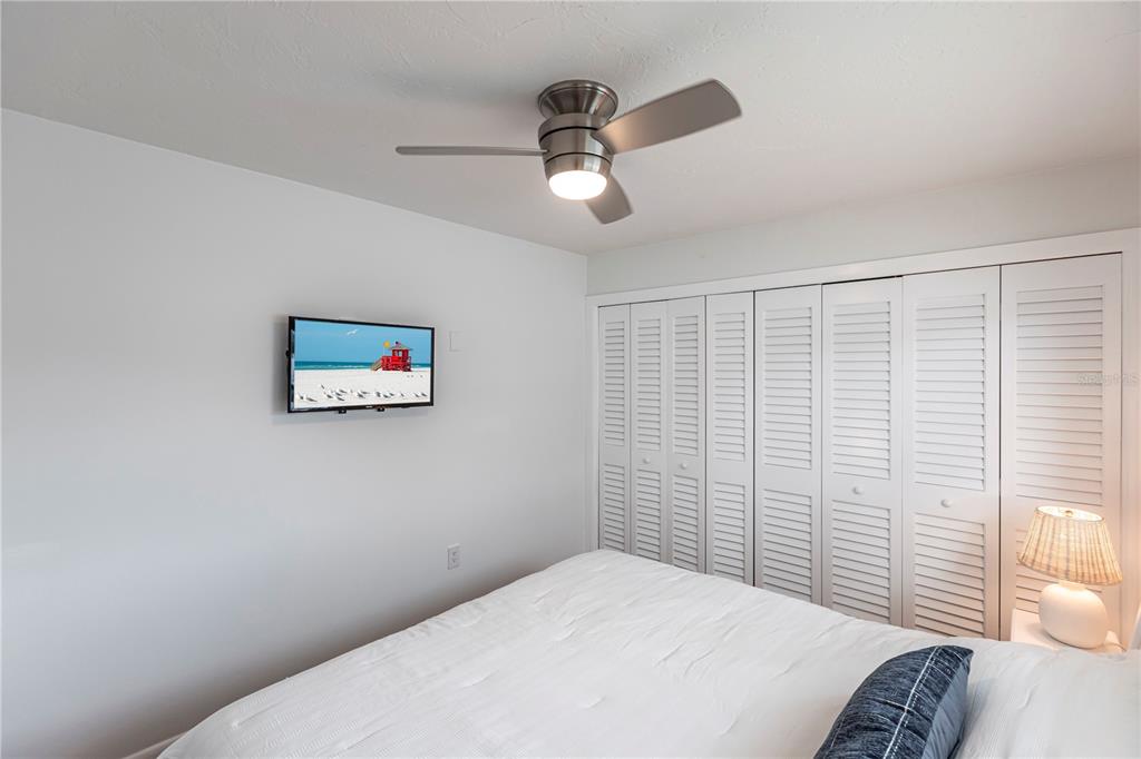 6020 Midnight Pass Road, Unit 48 Sarasota, FL 34242 - Photo 15 of 17 a bedroom with a bed and a window