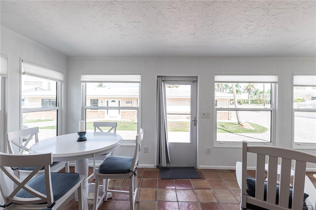 6020 Midnight Pass Road, Unit 48 Sarasota, FL 34242 - Photo 5 of 17 a view of a dining room with furniture window and outside view