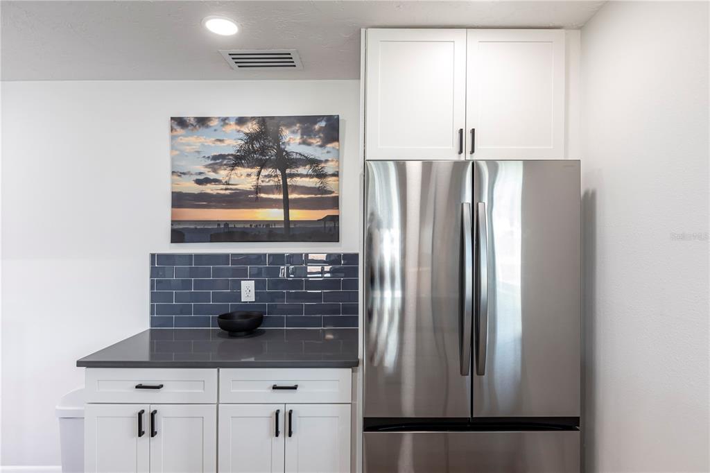 6020 Midnight Pass Road, Unit 48 Sarasota, FL 34242 - Photo 9 of 17 a kitchen with stainless steel appliances granite countertop a refrigerator and a sink