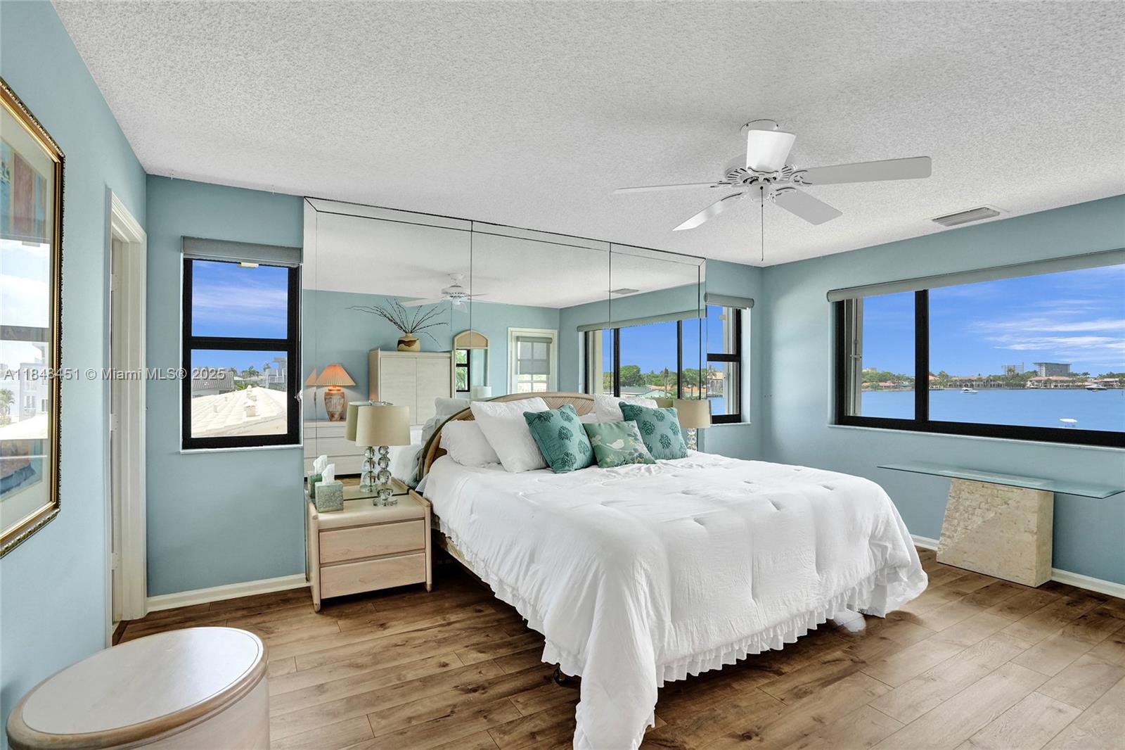 1101 South Riverside Drive, Unit 301 Pompano Beach, FL 33062 - Photo 18 of 40 a bedroom with a large bed and a chandelier