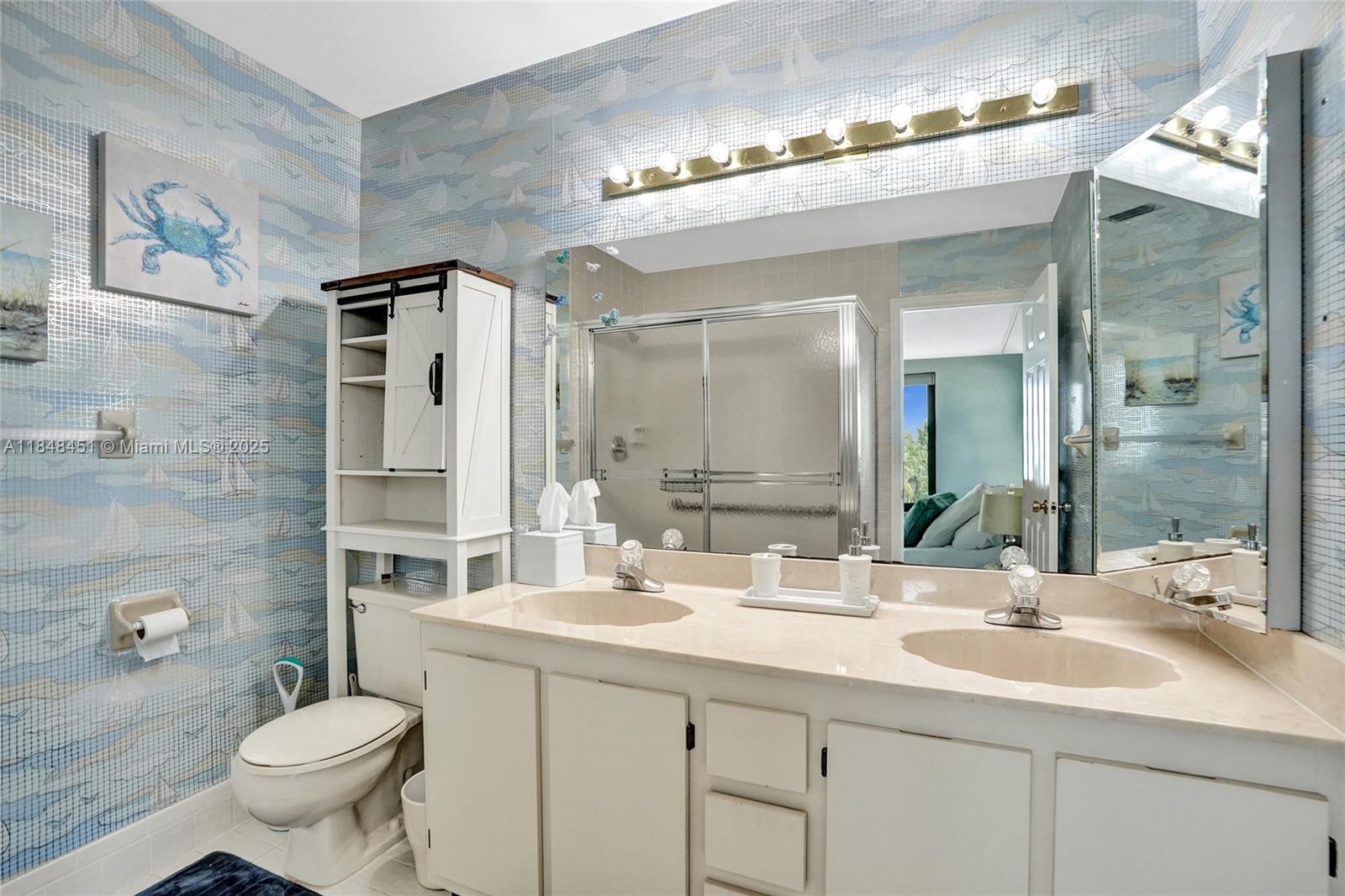 1101 South Riverside Drive, Unit 301 Pompano Beach, FL 33062 - Photo 23 of 40 a bathroom with a double vanity sink toilet and a mirror