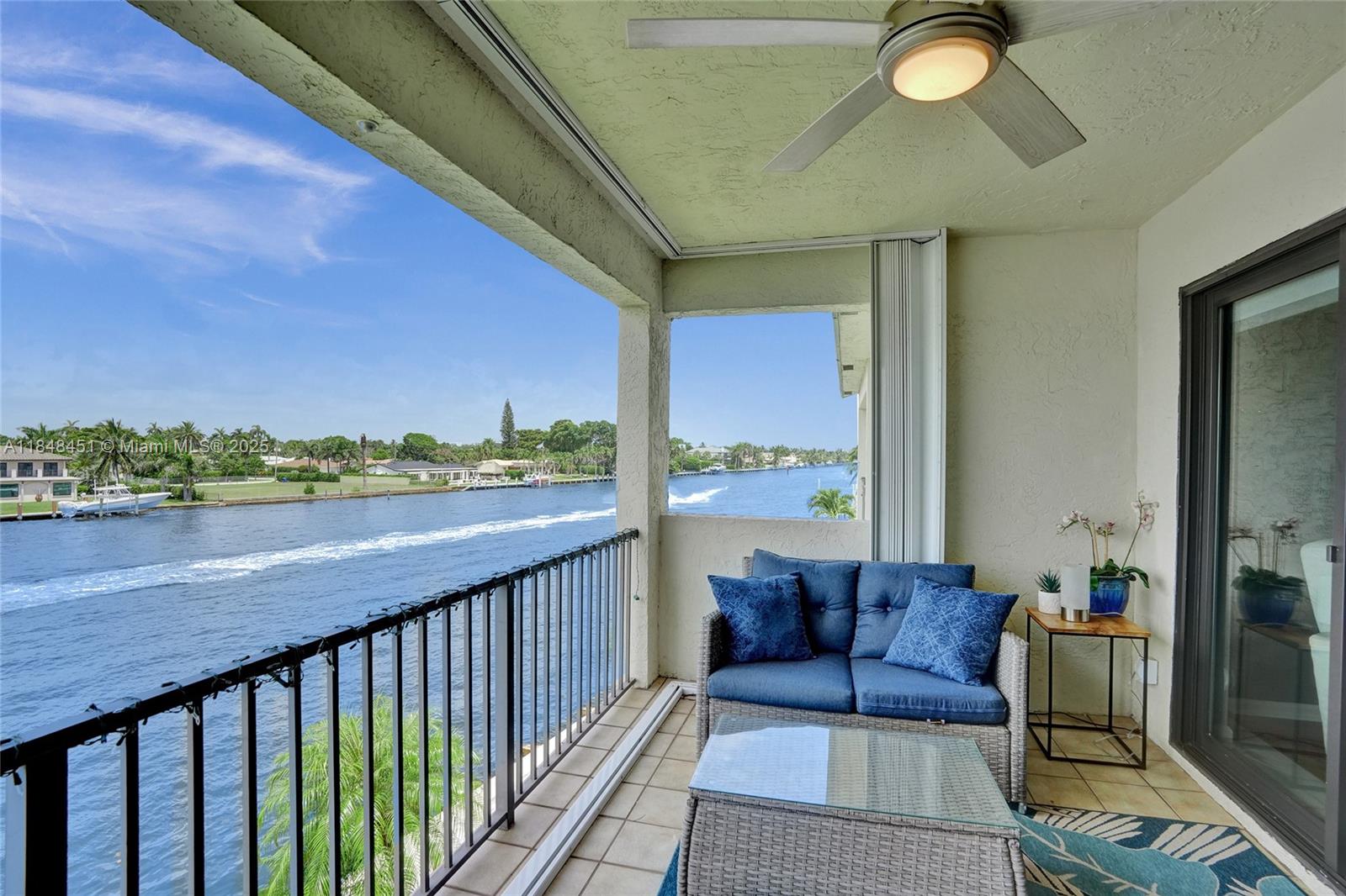 1101 South Riverside Drive, Unit 301 Pompano Beach, FL 33062 - Photo 40 of 40 a balcony with furniture and a potted plant