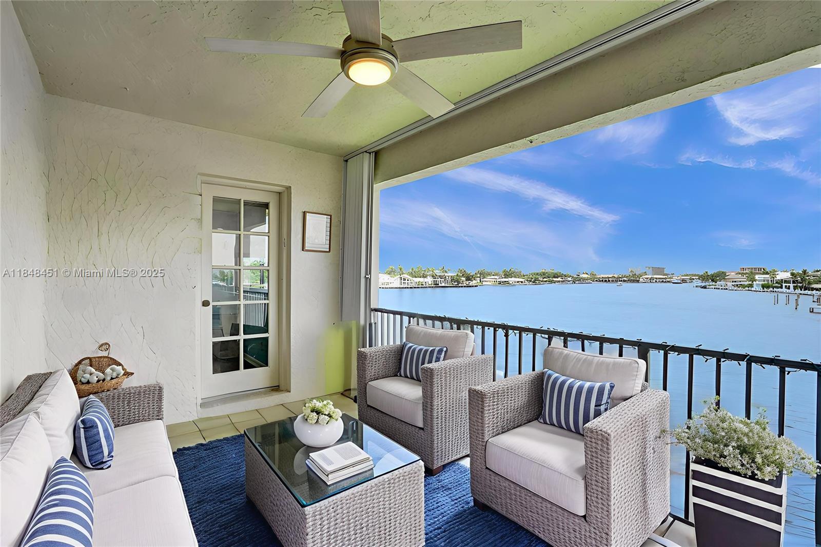 1101 South Riverside Drive, Unit 301 Pompano Beach, FL 33062 - Photo 5 of 40 a living room with furniture and a floor to ceiling window