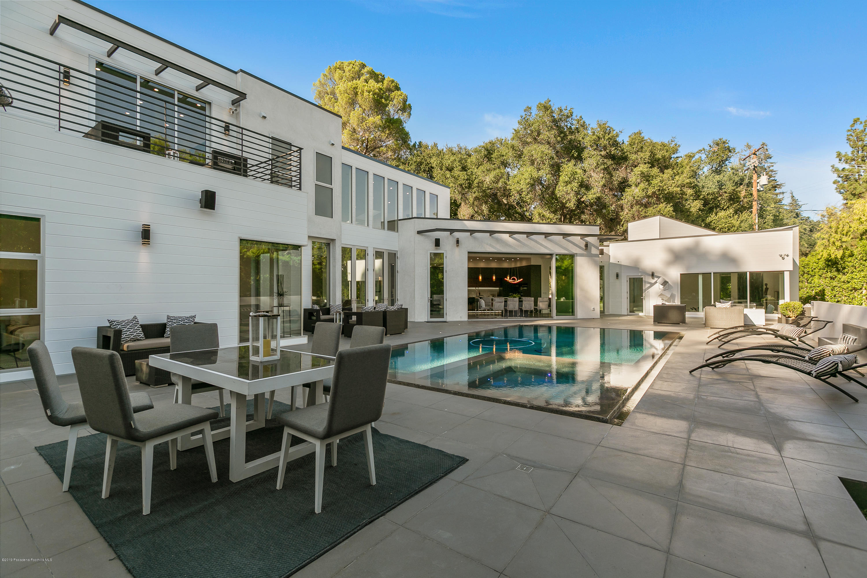 4402 Wasatch Drive La Canada Flintridge, CA 91011 - Photo 35 of 62 a view of a patio with table and chairs near a barbeque