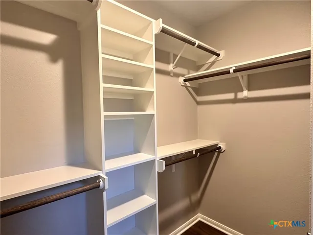 a view of closet with wooden floor