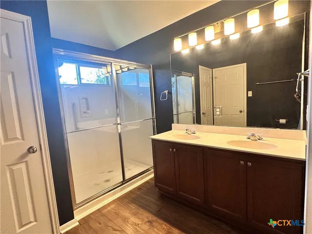 a bathroom with a double vanity sink and mirror