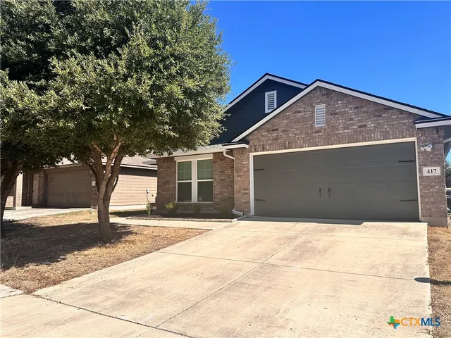 a view of garage with a tree