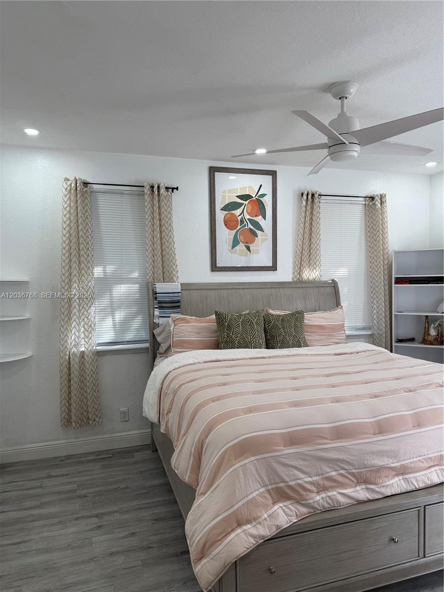 2432 Southwest 99th Way Miramar, FL 33025 - Photo 5 of 17 a bedroom with a bed and a chandelier