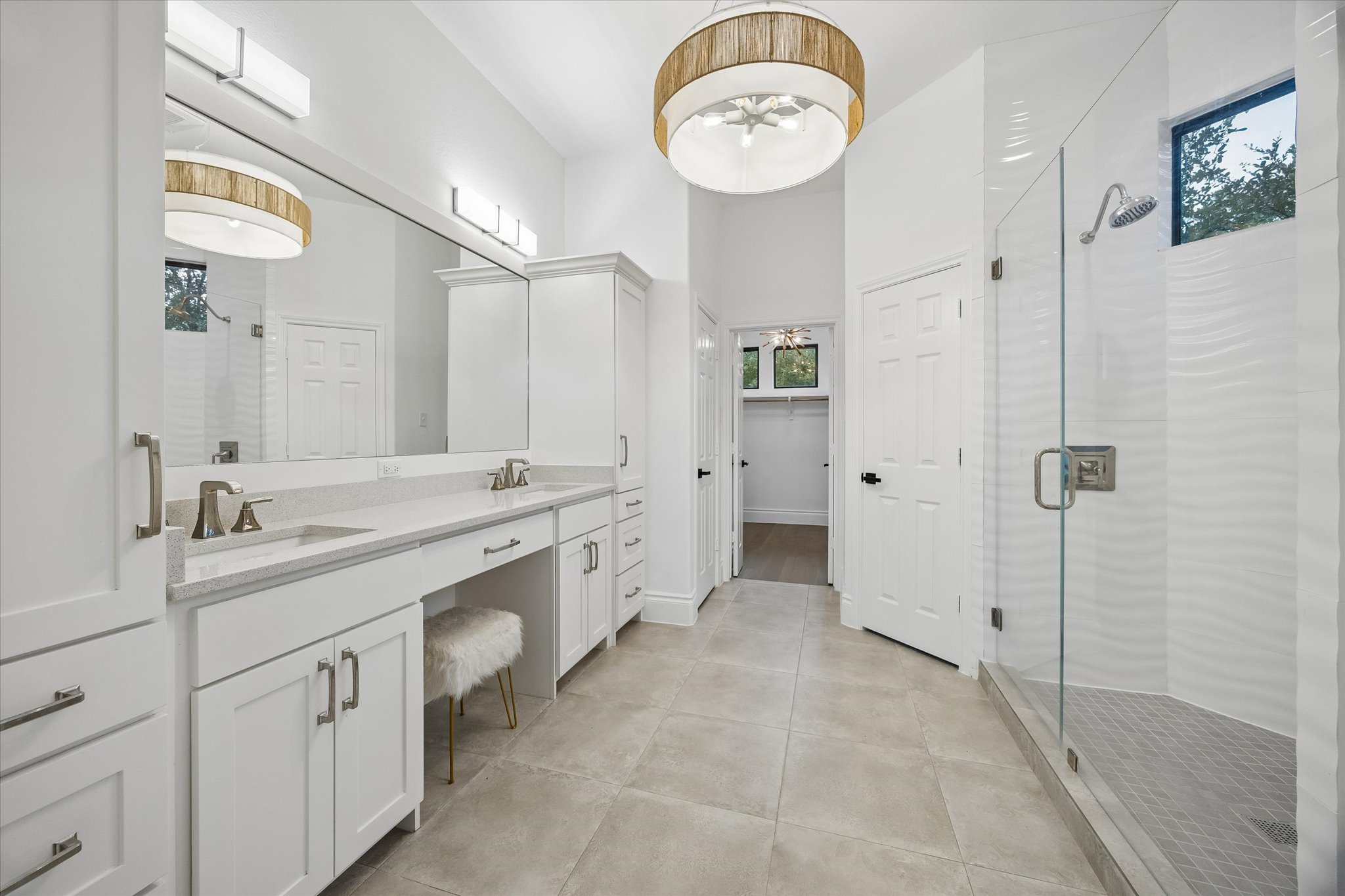 3719 Bee Creek Road Spicewood, TX 78669 - Photo 16 of 40 A well-lit primary bathroom provides ample counter space and a spacious walk-in shower.