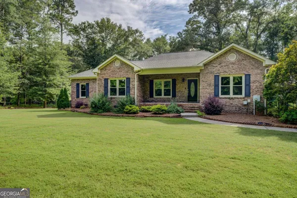 a front view of house with yard and green space