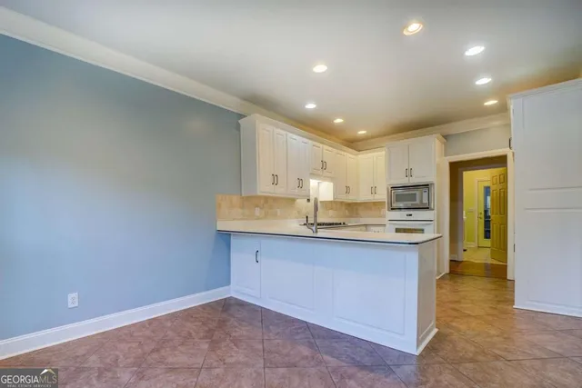 a kitchen with stainless steel appliances a sink stove and cabinets