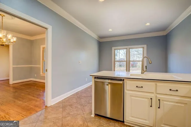 a view of a kitchen with wooden floor and cabinets