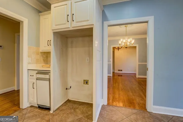 a kitchen with white cabinets stainless steel appliances and a counter space