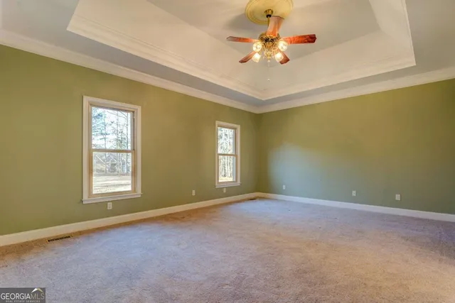 an empty room with closet and windows