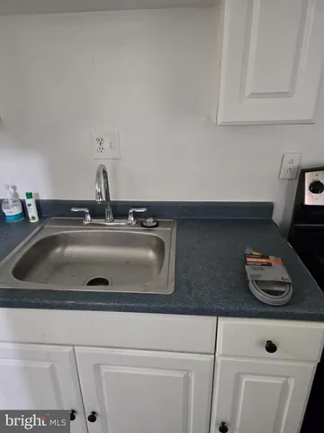 a kitchen with sink a cabinets and appliances