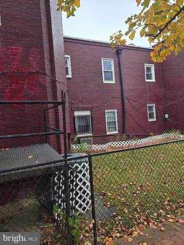 front view of a brick house with a large window