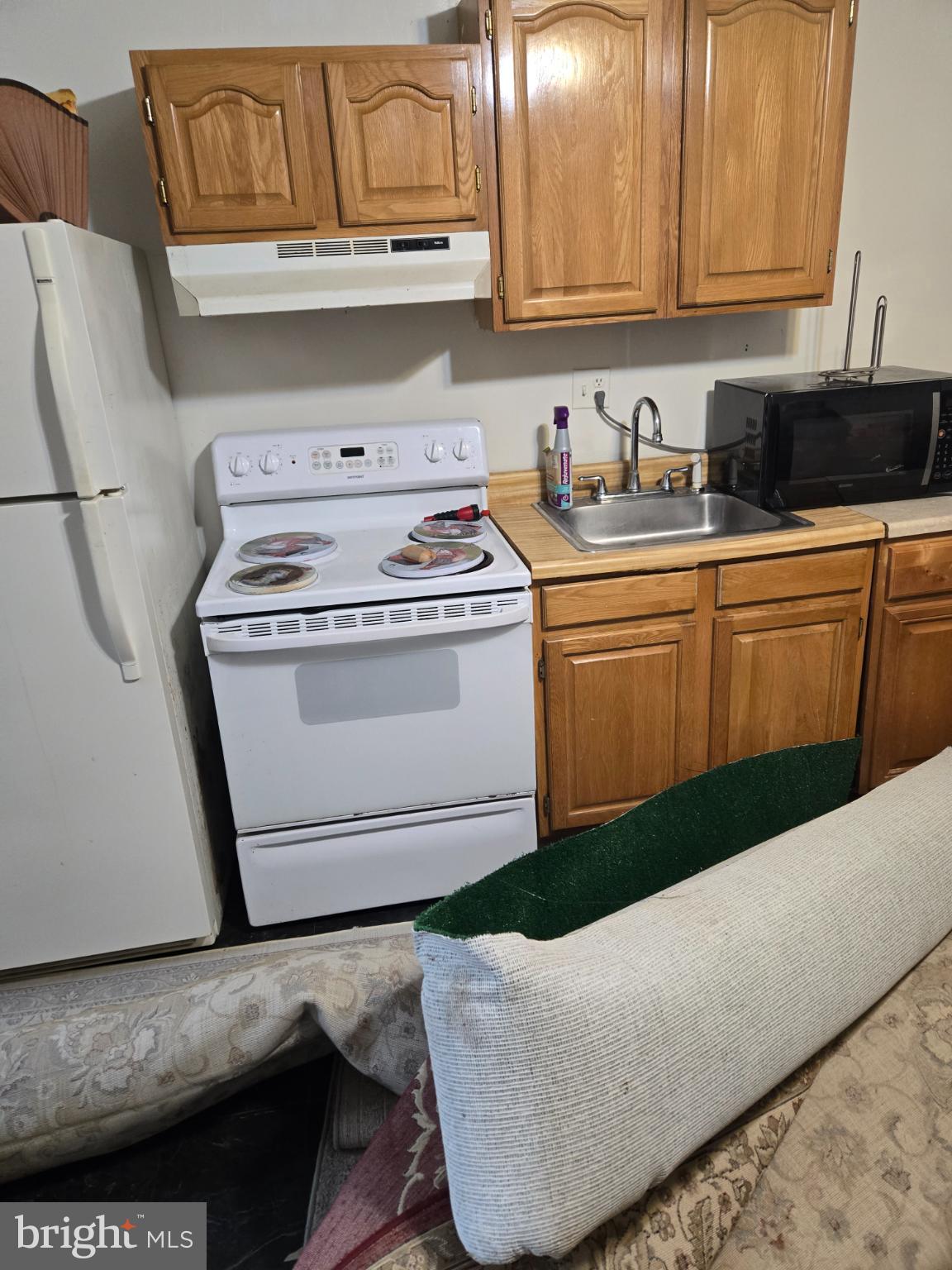 401 O Street Northwest Washington, DC 20001 - Photo 22 of 41 a kitchen with granite countertop wood cabinets and white appliances