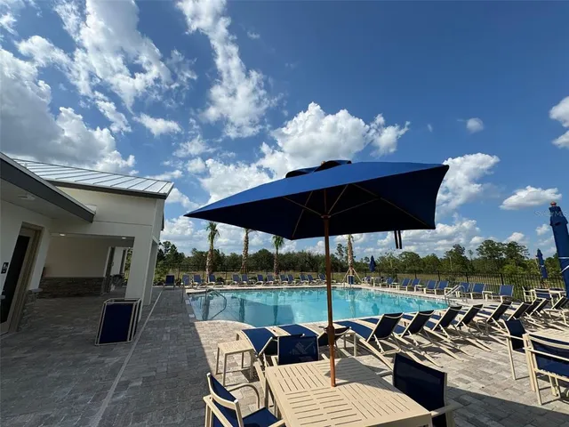 a view of a patio with couches under an umbrella