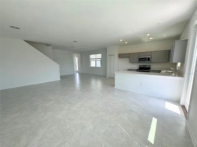 a view of a kitchen with a sink and a stove top oven