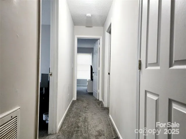 a view of a hallway with a dining area