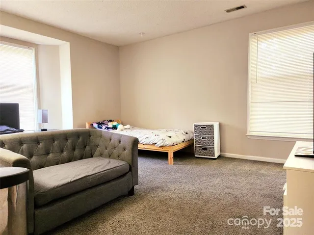 a bedroom with furniture and a window