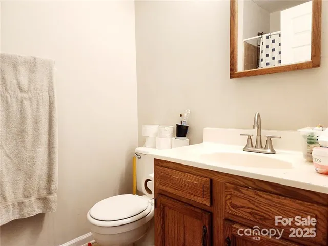 a bathroom with a toilet a sink and mirror