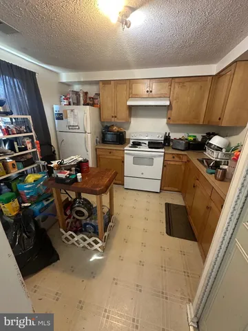 a kitchen with stainless steel appliances a stove a sink and a refrigerator