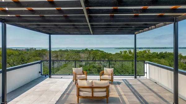 a view of a roof deck with couches and wooden floor