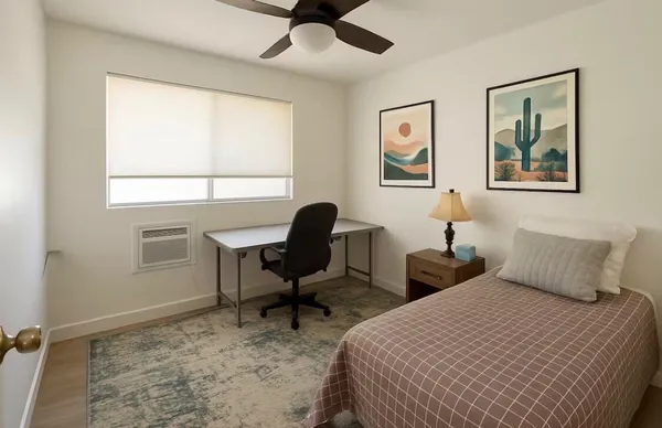 a bedroom with 2 bed and a window