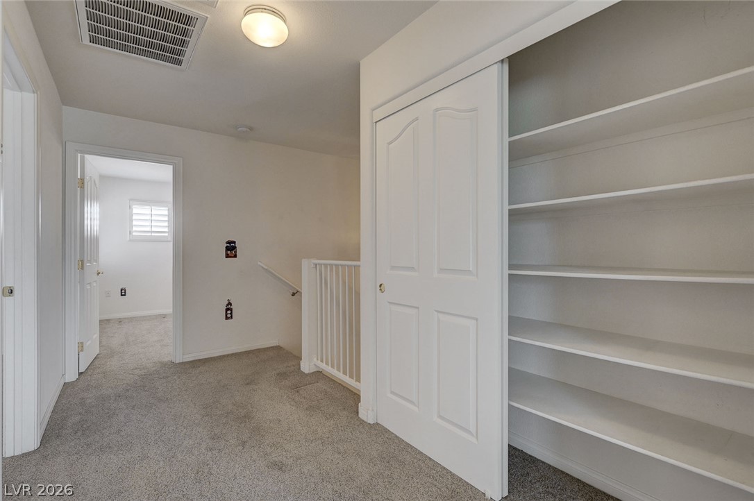 1479 Orange Jubilee Road Henderson, NV 89014 - Photo 17 of 36 Functional hallway closet with ample shelving provides generous storage space.