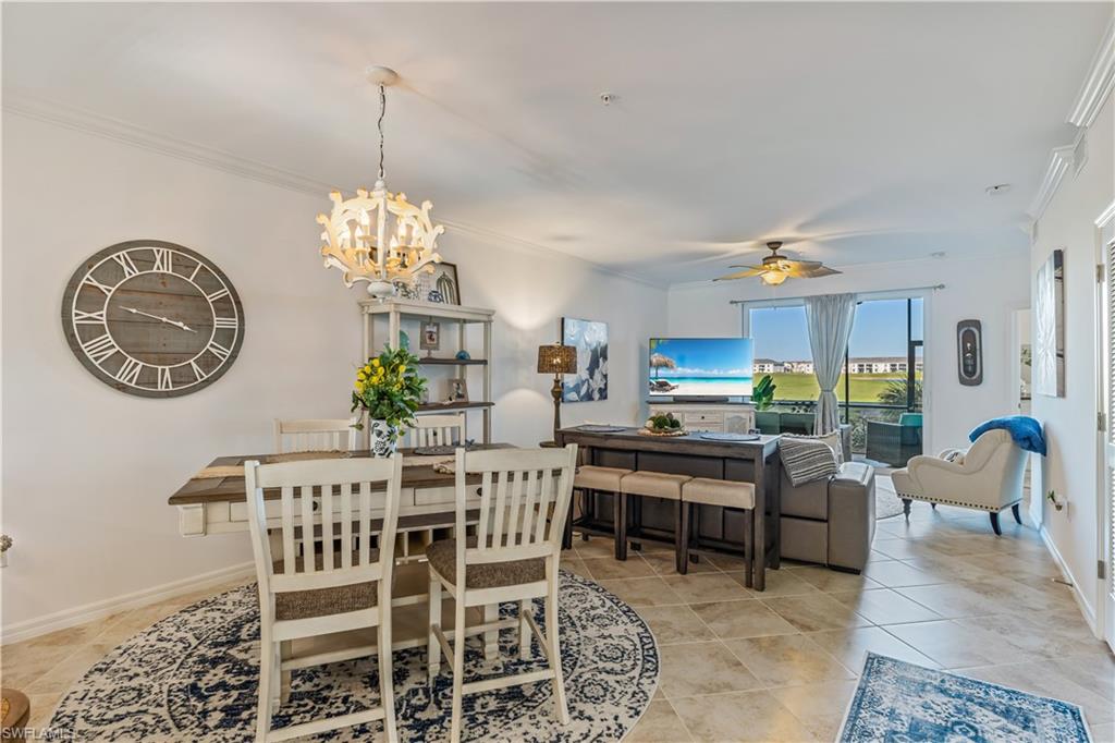 43031 Greenway Boulevard, Unit 1028 Babcock Ranch, FL 33982 - Photo 13 of 15 a dining room with furniture a rug and a chandelier