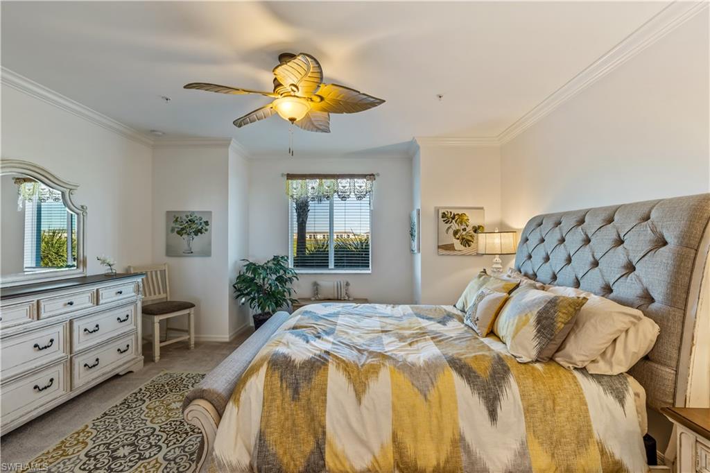 43031 Greenway Boulevard, Unit 1028 Babcock Ranch, FL 33982 - Photo 3 of 15 a bedroom with a bed and a chandelier