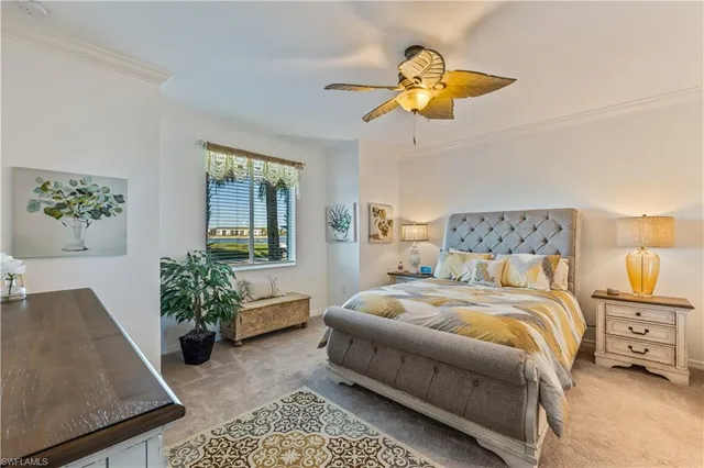 a bedroom with a bed and chandelier