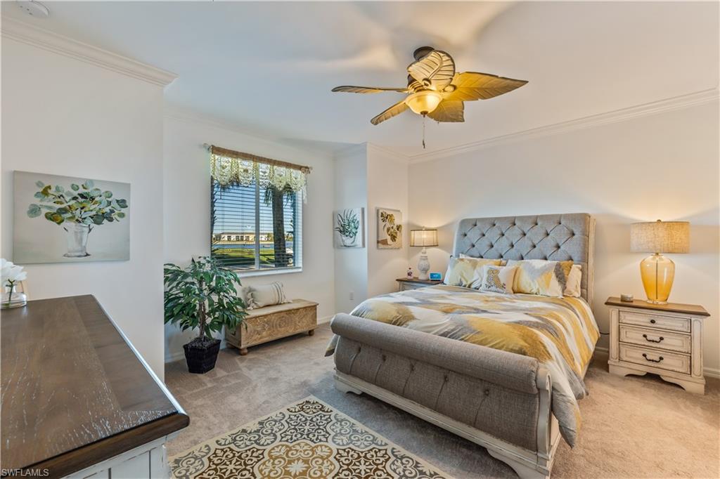 43031 Greenway Boulevard, Unit 1028 Babcock Ranch, FL 33982 - Photo 4 of 15 a bedroom with a bed and chandelier