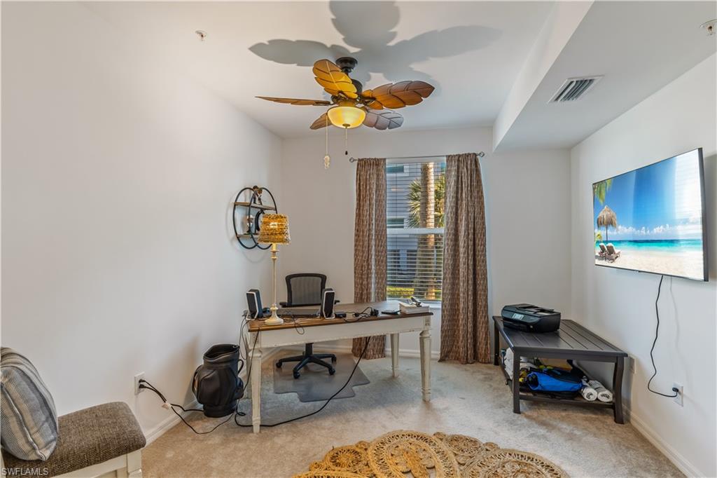 43031 Greenway Boulevard, Unit 1028 Babcock Ranch, FL 33982 - Photo 6 of 15 a living room with furniture a rug and a chandelier