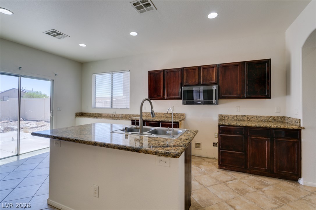 5150 Riverside Run Court North Las Vegas, NV 89081 - Photo 32 of 50 A functional kitchen island anchors this inviting space, perfect for culinary endeavors and casual dining.