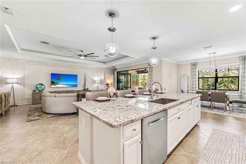 a large kitchen with kitchen island a sink counter space and living room view