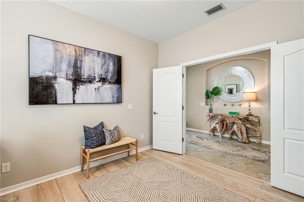 4686 Abaca Circle Naples, FL 34119 - Photo 6 of 47 a bedroom with furniture and a potted plant