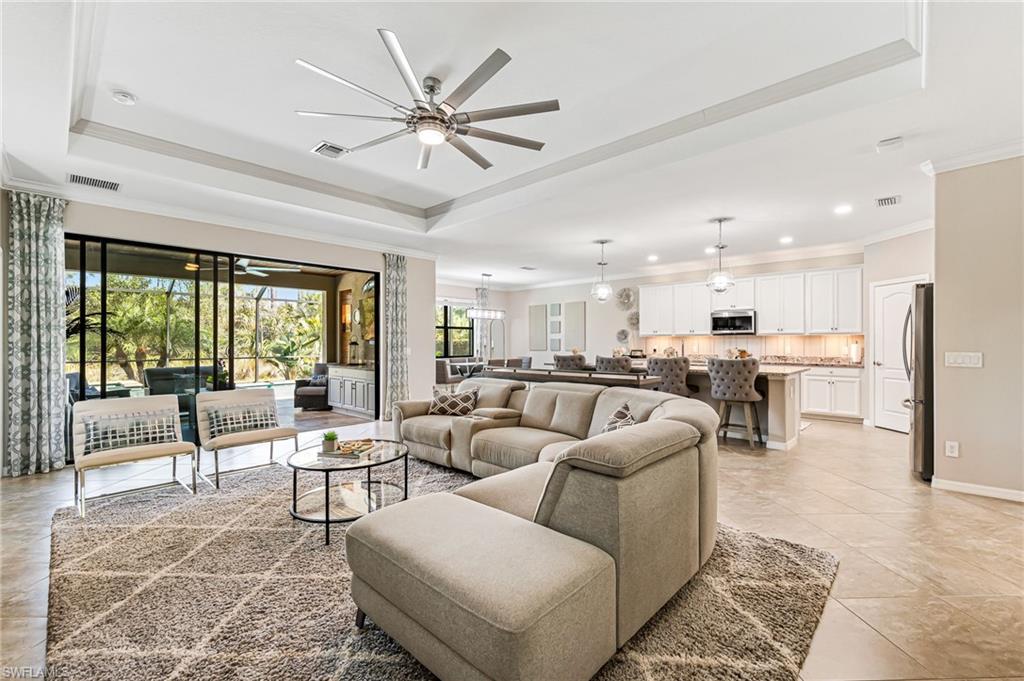 4686 Abaca Circle Naples, FL 34119 - Photo 9 of 47 a living room with furniture and a large window