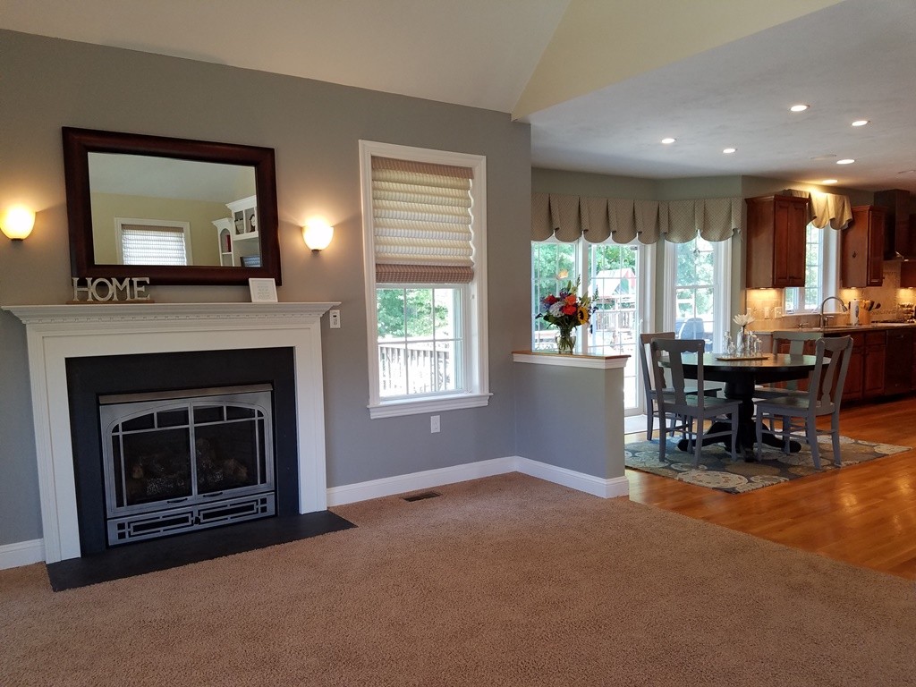 39 Ridgewood Street Ashland, MA 01721 - Photo 11 of 30 a living room with furniture and a fireplace