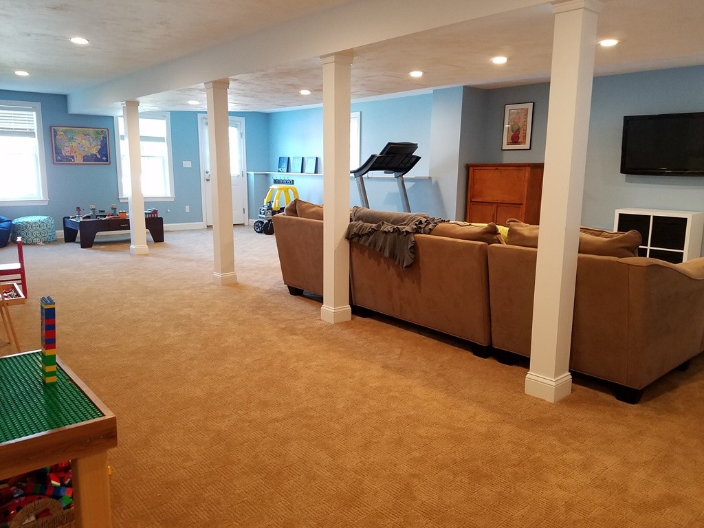 39 Ridgewood Street Ashland, MA 01721 - Photo 28 of 30 a living room with furniture and a flat screen tv