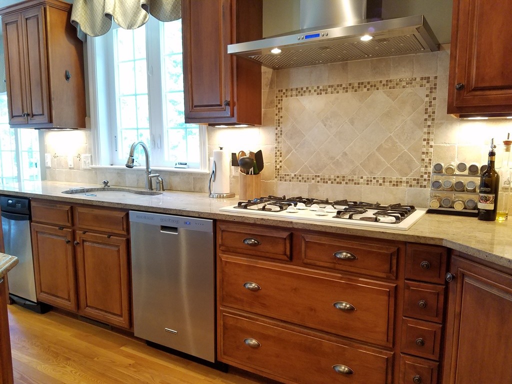 39 Ridgewood Street Ashland, MA 01721 - Photo 7 of 30 a kitchen with granite countertop wooden cabinets and white appliances