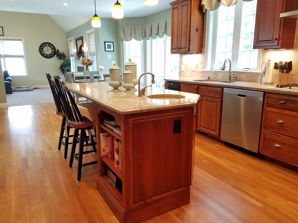 39 Ridgewood Street Ashland, MA 01721 - Photo 8 of 30 a kitchen with a sink cabinets and wooden floor
